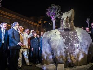 Egyptian Antiquities Minister Khaled el-Anani (2nd-L) and Denmark's Prince Henrik (3rd-L), look at the torso part of a statue believed to depict King Psamtek I, outside the Egyptian Museum in Cairo on March 16, 2017. (AFP/Khaled Desouki)