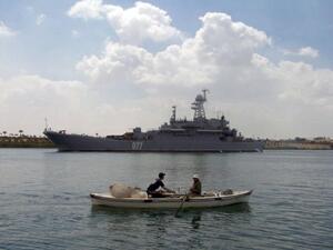 Egyptian fishermen row past a warship. (AFP/File)
