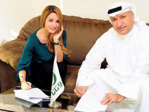 Diana Haddad signs the big contract! (Image: Facebook)