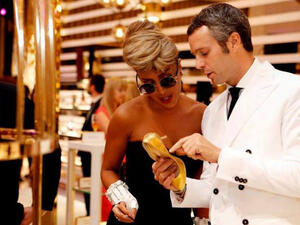 Maya Diab inspecting her gold-plated shoe (Image: Facebook)