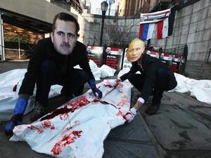 Activists dress up as the Syrian and Russian presidents Activists dress up as the Syrian and Russian presidents