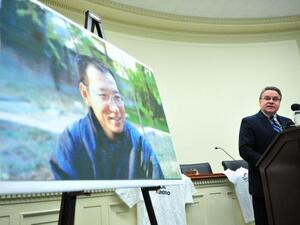U.S. Rep. Christopher Smith honouring Liu Xiaobo (pictured in the background). (Kevin Dietich / UPI)