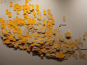 A new exhibit uses toe tags with the names of dead migrants found at the Arizona-Mexico border from 1994 as a graphic reminder that crossing borders claims lives. (Photo courtesy of "Hostile Terrain 94.")