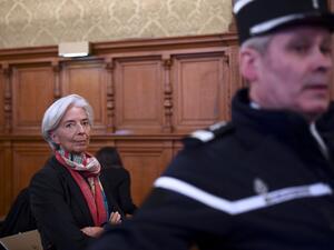 IMF chief Christine Lagarde next to a Gendarme prior to the start of her trial before the Court of Justice of the Republic, a special tribunal used to try ministers. (AFP/Martin Bureau) IMF chief Christine Lagarde next to a Gendarme prior to the start of her trial before the Court of Justice of the Republic, a special tribunal used to try ministers. (AFP/Martin Bureau)