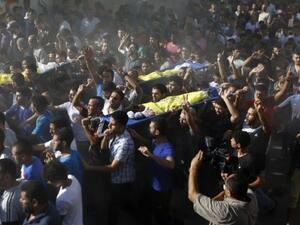 Mourners attend a funeral for Palestinian boys from the Bakr family, who were killed on a beach in 2014. (AFP/File)