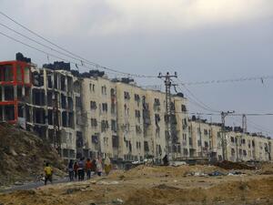 Palestinians walk near destroyed buildings in the northern Gaza Strip. (AFP/Mohammed Abed)