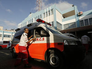 A Palestinian Red Crescent worker washes his ambulance after carrying wounded in Beit Lahia in the northern Gaza Strip. (AFP/ File)