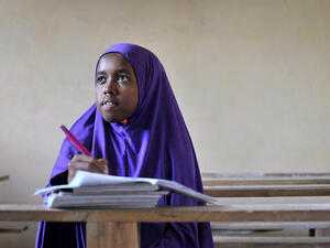 A student wearing a hijab takes notes in her exercise book (Image for illustrative purposes - Credit: AFP)
