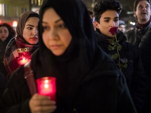 People mourn on December 20, 2016 at a makeshift memorial in front of the Kaiser Wilhelm Memorial Church in Berlin, where a truck crashed the day before into a Christmas market. (AFP/Odd Andersen)