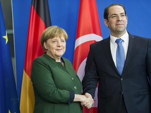 German Chancellor Angela Merkel and Tunisian Prime Minister Youssef Chahed shake hands after a press conference at the Chancellery in Berlin on February 14, 2017. (AFP/File)