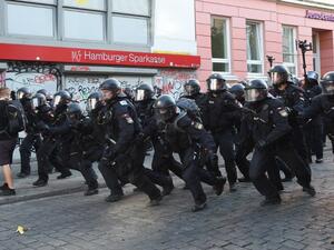 Riot police charge forward towards protesters on July 8, 2017 in Hamburg, northern Germany as world leaders meet during the G20 summit (Christof Stache/AFP)