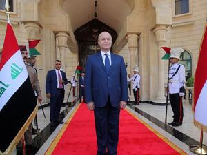 Newly elected Iraqi President Kurdish Barham Saleh greets the crowd during the handing over ceremony in Baghdad. (AFP/Sabah Arar)