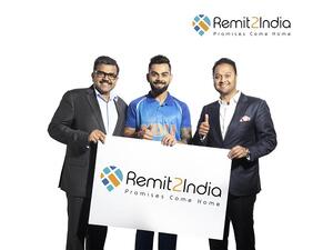 Indian Cricket Captain Virat Kohli with Finablr Executive Director Binay Shetty (right), and Finablr Executive Director Promoth Manghat (left).