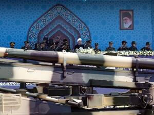 An Iranian medium range missile Zelzal passes by Iranian President Hassan Rouhani during an annual military parade. (str/afp)