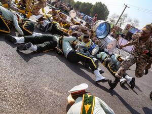 On September 22, 2018 in the southwestern Iranian city of Ahvaz shows a soldier running past injured comrades lying on the ground at the scene of an attack on a military parade. (AFP/File)