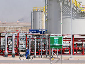 An Iraqi labourer rides a bike in the newly opened section at the oil refinery of Zubair, southwest of Basra in southern Iraq. (AFP/File)