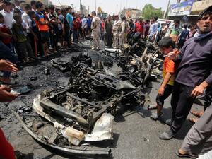 Iraqis gather at the scene of a car bombing in Sadr City in May. (AFP/File)