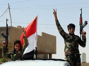 Iraqi government forces celebrate in the town of Sharqat, around 50 miles south of the city of Mosul, on September 23, 2016. (AFP/Ahmad al-Rubaye)