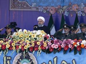 Iranian President Hassan Rouhani (C) and senior members of his armed forces watch a parade on the occasion of the country's annual Army Day on April 18, 2018, in Tehran. President Hassan Rouhani said during the parade that Iran "does not intend any aggression" against its neighbours but will continue to produce all the weapons it needs for its defence. ATTA KENARE / AFP