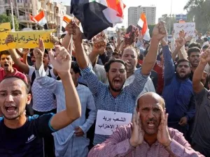 Iraqis shout slogans during a protest in Najaf.  (AFP/ File Photo)