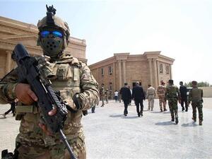 A member of the Iraqi security forces stands guard in front of the local government headquarters in the southern city of Basra, in Iraq, on September 18, 2018. (AFP/File Photo)