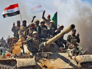 Fighters from the Hashed al-Shaabi (Popular Mobilisation units), backing Iraqi forces, advance towards the Islamic State (IS) group's stronghold of Hawija on October 4, 2017 (Ahmad al-Rubaye/AFP)