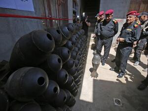 Iraqi commanders Abdul Ghani al-Asadi and Ma'an al-Saadi check a weapons store left by Islamic State (group) fighters in a house in western Mosul on May 21, 2017, during the ongoing offensive to retake the area from the jihadists. (Ahmad Al-Rubaye/AFP)