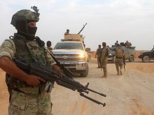 Iraqi forces are seen outside the town of Akashat, northwest of the al-Anbar province, as they prepare a military operation to push out ISIS (Moadh Al-Dulaimi/AFP)