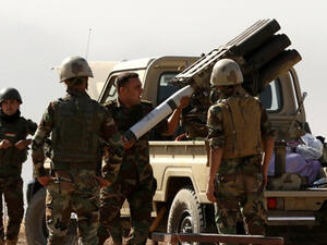 Iraqi forces load artillery outside Mosul (AFP)