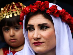 Wearing traditional Yazidi clothes, holding candles and paraffin lamps, Yazidis gather in the holy town of Lalish.(AFP)