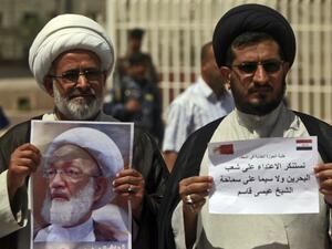 Iraqi Shiite clerics hold a picture of top Bahraini Shiite cleric Isa Qassim during a demonstration in front of the Bahraini consulate in Najaf on May 24, 2017 in solidarity with the Bahraini Shiite opposition and with the leading cleric. (Haidar Hamdani/AFP)