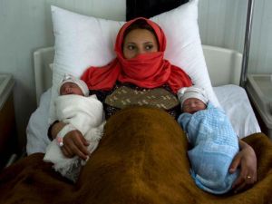 A mother of twins at a refugee camp near Mosul (AFP)