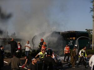 Firefighters respond to the scene of the Jerusalem bus blast. (AFP/Ahmad Gharabli)