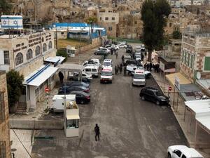 Police an ambulances respond to a shooting attack in January near the Ibrahimi Mosque. (AFP/Hazem Bader)