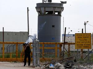 An Israeli guard fires tear gas at Palestinian protesters outside of Ofer prison. (AFP/File)