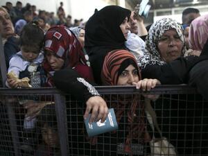 Palestinians wait at the Rafah border crossing with Egypt, in the southern Gaza Strip, after it was opened for two days by Egyptian authorities, on May 11, 2016. (AFP/Said Khatib)