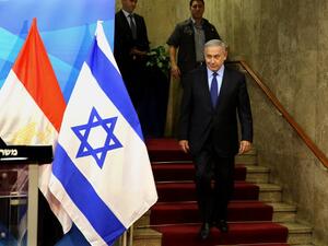 Israeli Prime Minister Benjamin Netanyahu walks to welcome the Egyptian foreign minister prior to their meeting at his Jerusalem office on July 10, 2016. (AFP/Gali Tibbon)
