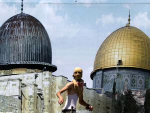 A Palestinian protester stands in front of a mural covered in an image of the Dome of the Rock during clashes between demonstrators and Israeli security forces at the Huwara checkpoint, south of Nablus. (AFP) 