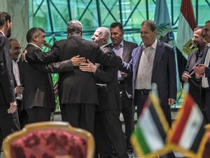 Khaled Fawzi (3rd-L) head of the Egyptian Intelligence services, shares a laugh with Hamas leader Izzat al-Rishq (2nd-L) and Fatah's Azzam al-Ahmad (C) following the signing of a reconciliation deal in Cairo on October 12, 2017 (Khaled Desouki/AFP)