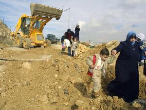 Palestinians walk along a demolished road by Israel leading to the village of Al Walaja in the West Bank. (Musa Al Shaer/ AFP)