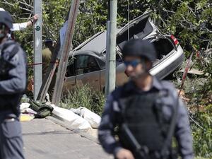 Israeli security forces stand guard at the site of a car ramming attack outside the Israeli settlement of Ofra, north of the Palestinian city of Ramallah, on April 6, 2017. (AFP/Thomas Coex)