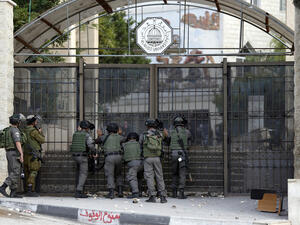 Israeli guards stand outside the gate of al-Quds University in 2015. (AFP/File)