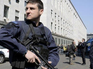 Police officers stand guard outside a court in Milan. (AFP/File)