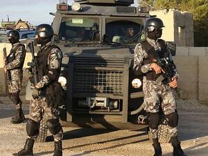 Jordanian security forces are seen on December 19, 2016 during the funeral of victims who were killed a day earlier in an attack at in Karak. (AFP/ KHALIL MAZRAAWI)