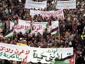 Jordanian Islamic Action Front supporters shouts anti-Government slogans, in Amman, on 18 November 2011, as hundreds of Jordanian protesters mached following Friday noon prayer.