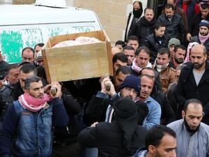 Jordanian mourners carry the coffin of Ibrahim Bashbsha, a day after he died in an attack, on December 19, 2016 during his funeral in Karak, around 70 miles south of the capital Amman. (AFP/Khalil Mazraawi)