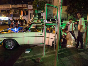 Books are displayed on Nancy, the vintage Mercedes that Ghaith Bahdoosh drives around Amman to bring the joy of reading to the people. (Lindsey Leger)