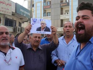 Demonstrators shout slogans during a demonstration in the town of Fuheis, 20km northwest of Amman on September 25, 2016, denouncing the killing of prominent Jordanian writer Nahed Hattar. (AFP/Khalil Mazraawi)
