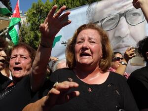 Mourners chant slogans and wave the national flag during the funeral of Jordanian writer Nahed Hattar, who was shot dead earlier this week outside an Amman court, in the town of Fuheis, 20km northwest of the capital Amman on September 28, 2016. (AFP/Khalil Mazraawi)