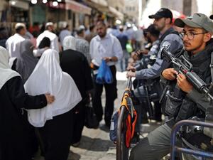 Israeli police stand guard in the main street of the Muslim Quarter in Jerusalem's Old City (AFP/File Photo)